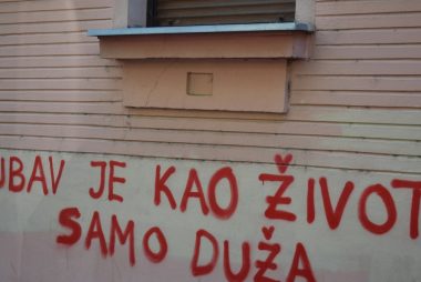 Red graffiti on a building wall